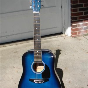 Lousy 3/4 size Harmony that I bought almost untouched for $25 with a gig bag.  The kids use it and I don't have to worry about it.