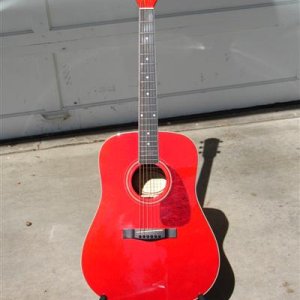 Squier acoustic, that sounds really good.  And it holds it's tuning really well also.  Paid $75, came with hard case, stand and beginner's book.